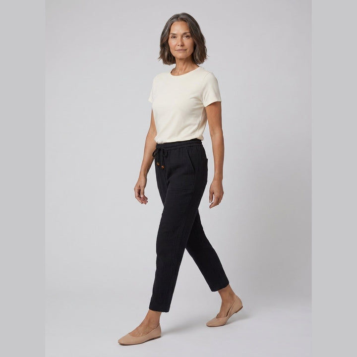 Dara black tapered pants front walking pose