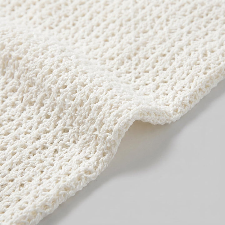Close-up of the white crochet knit fabric