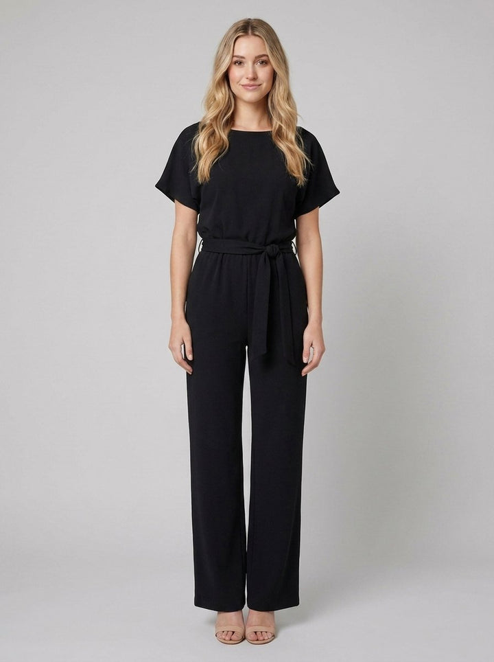 Black wide-leg jumpsuit with self-tie belt on model, front view