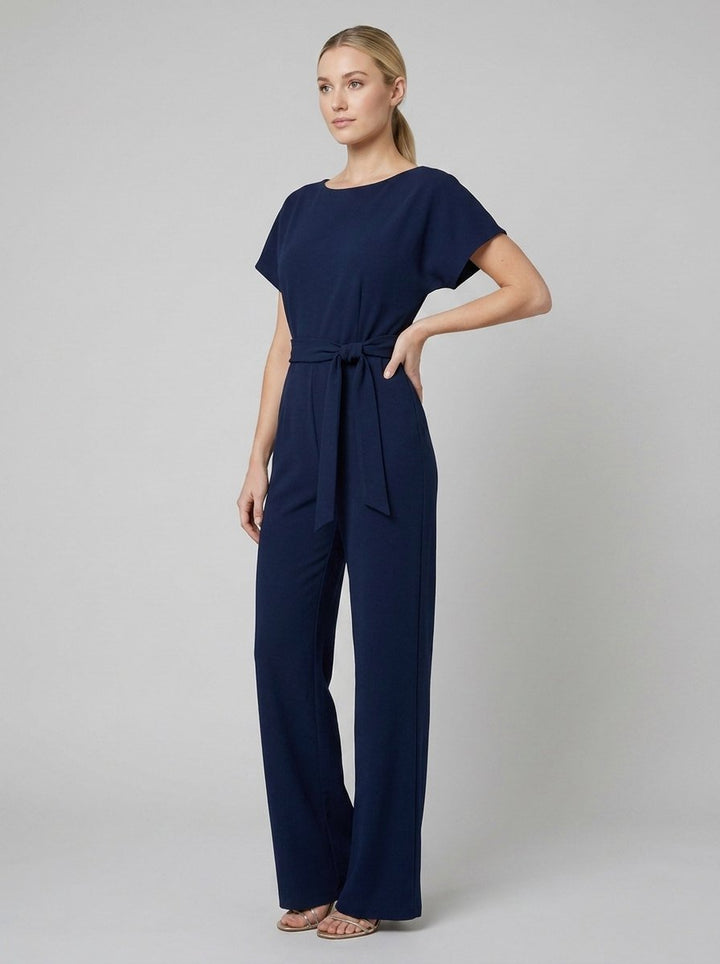 Navy blue wide-leg jumpsuit with self-tie belt on model, front view