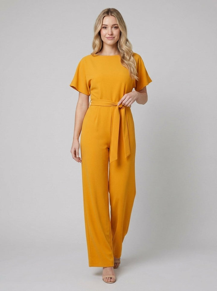 Yellow wide-leg jumpsuit with self-tie belt on model, front view