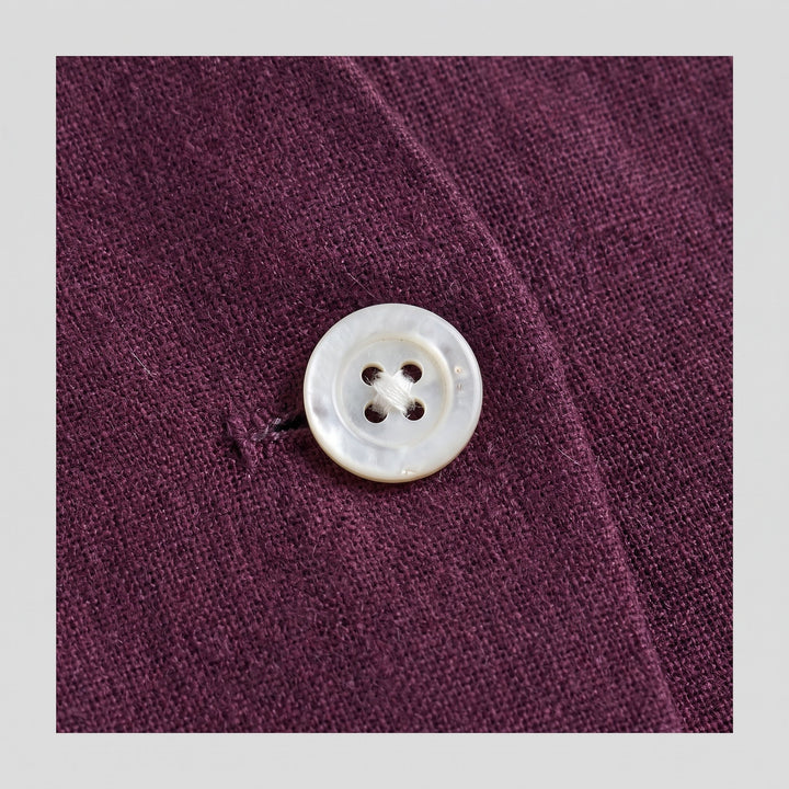 Blythe aubergine vest fabric close-up with button detail