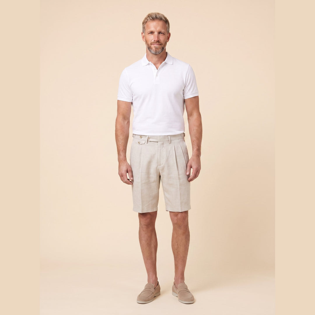 Man in oatmeal linen pleated Brenlin Bermuda shorts, front view