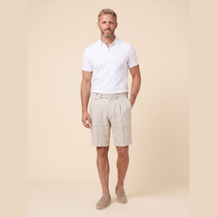 Oatmeal linen Brenlin Bermuda shorts on model, relaxed pose