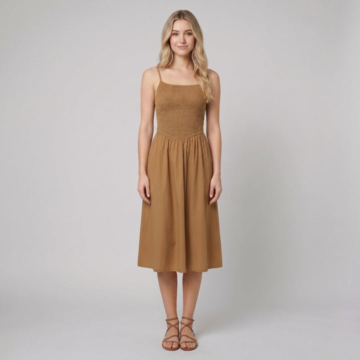 Brown A-line midi dress with a smocked bodice and spaghetti straps, front view on model