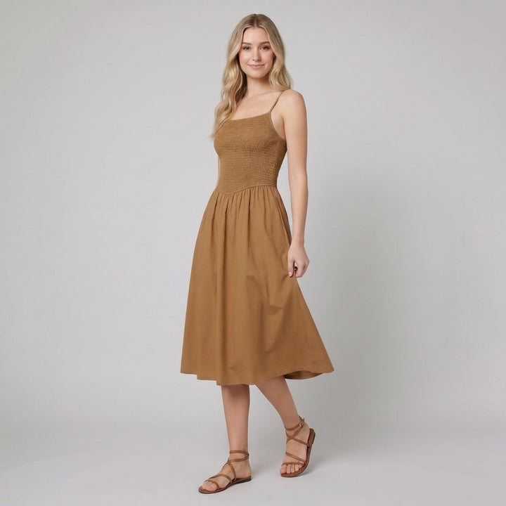 Brown A-line midi dress with a smocked bodice, side view on model