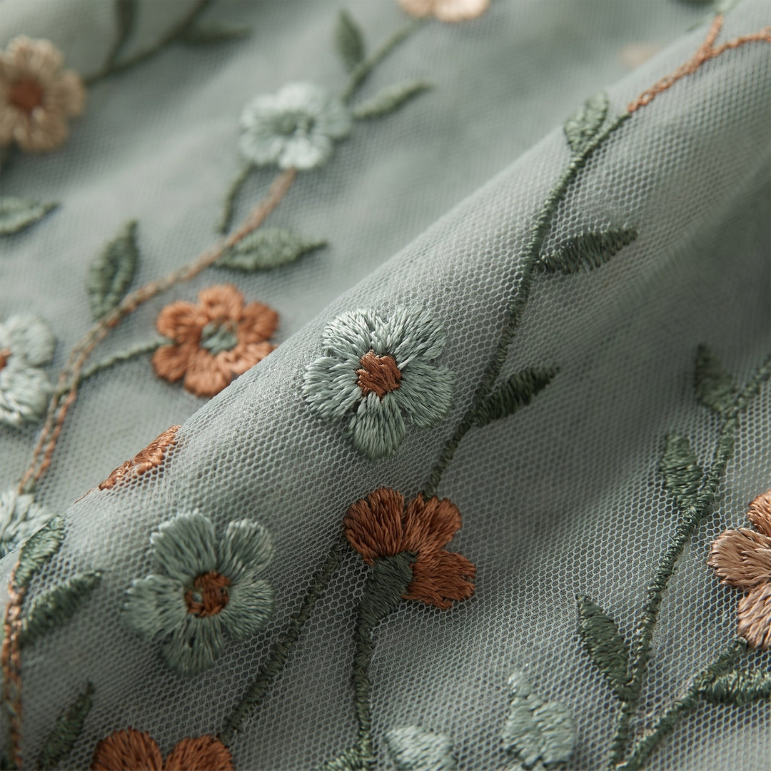 Close-up of the sage green floral embroidered mesh fabric - The store Vancouver