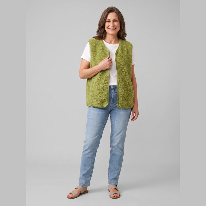 Faustine sherpa fleece vest in olive green worn over a knit