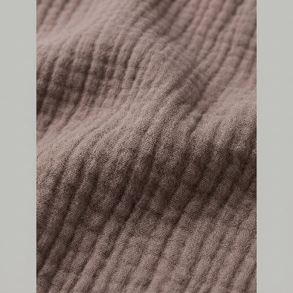 Close-up of the taupe polyester fabric of the set