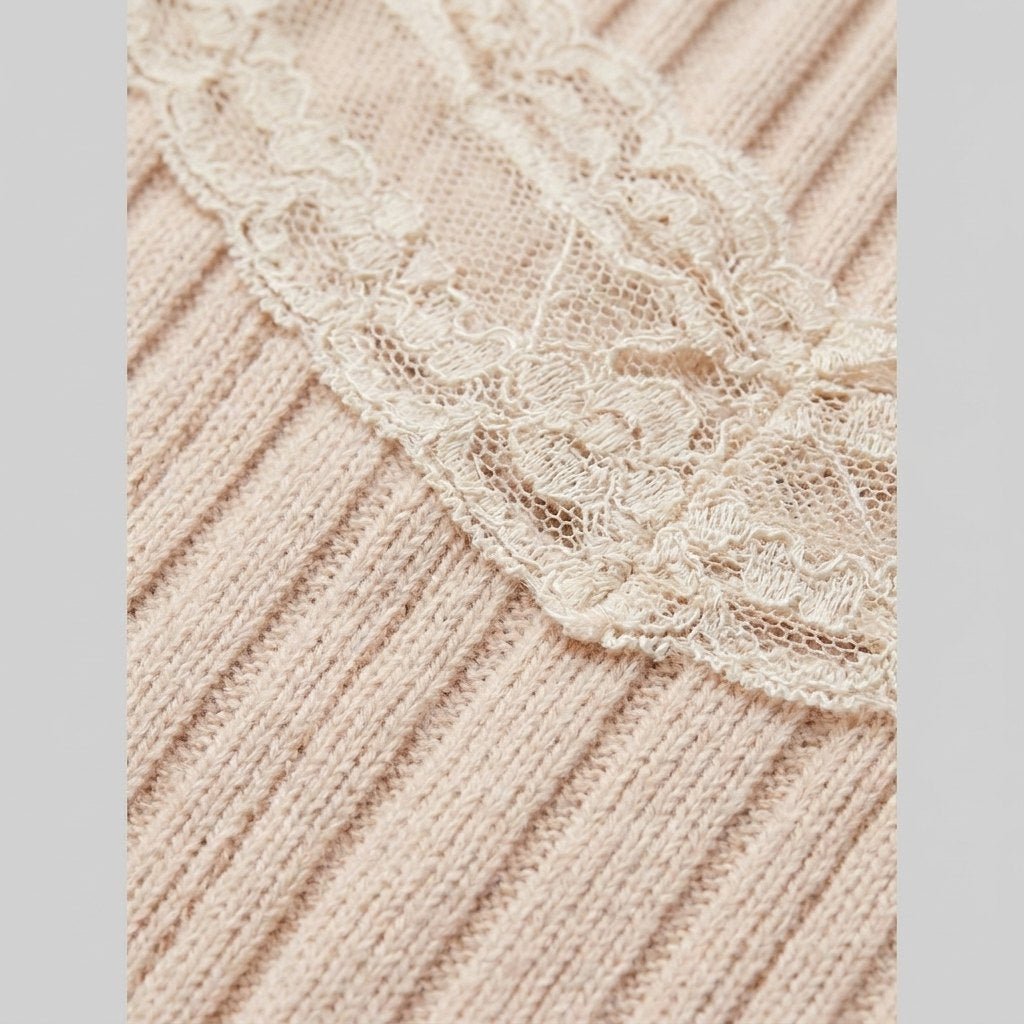 Close-up of the beige knit fabric and bow detail