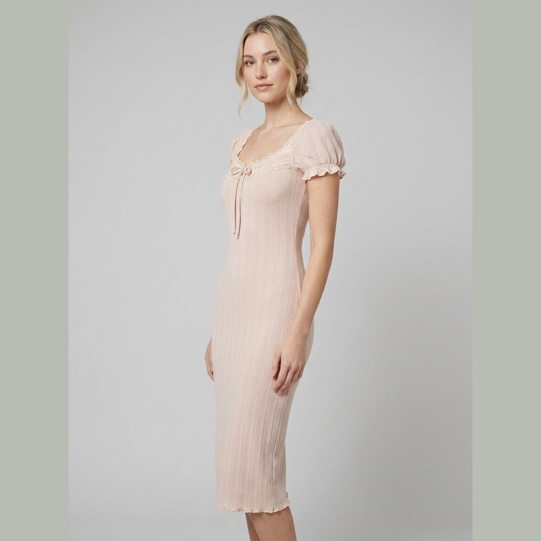 Beige knit mini dress with puff sleeves, side view on model
