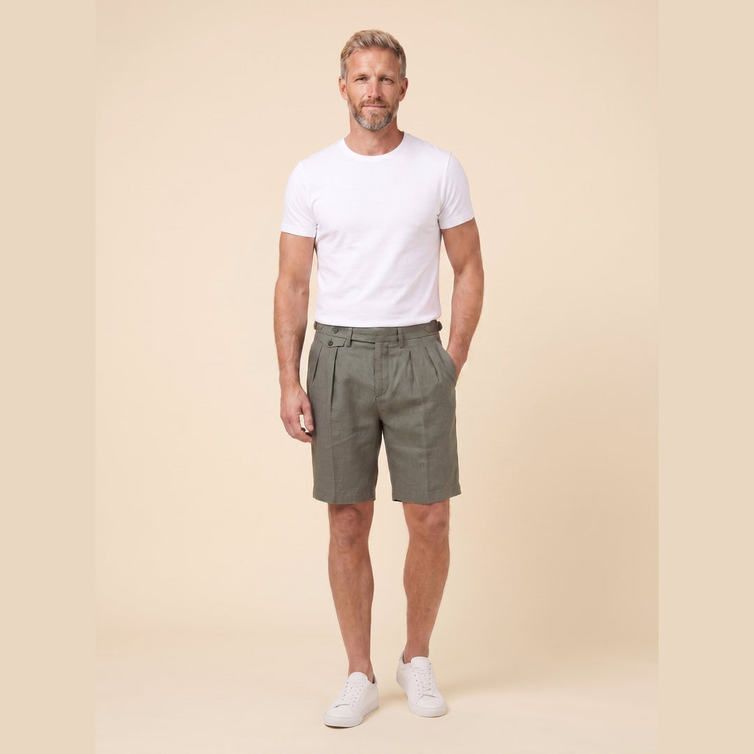Olive linen Linden Bermuda shorts on model, relaxed pose