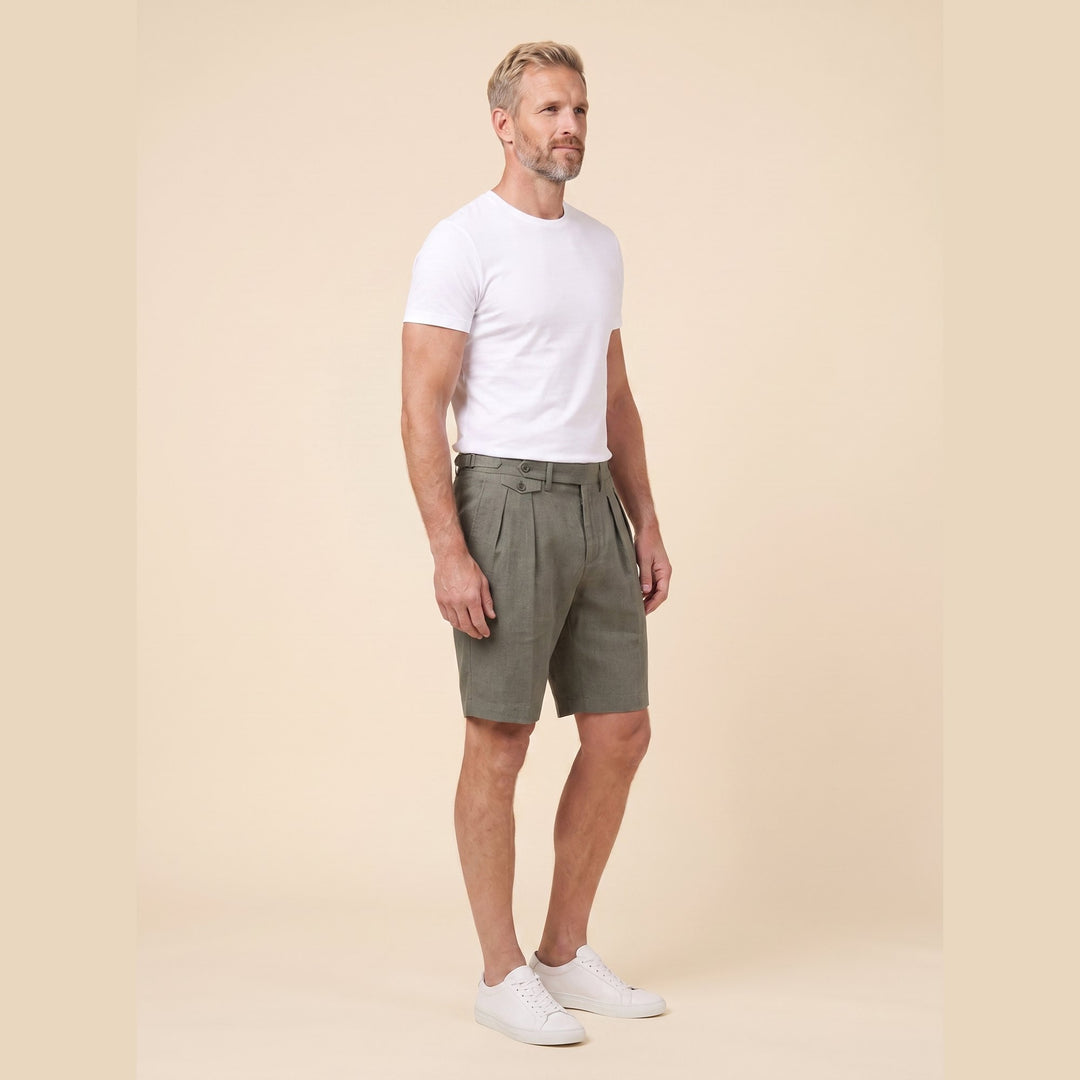 Olive linen Linden Bermuda shorts, side view on model