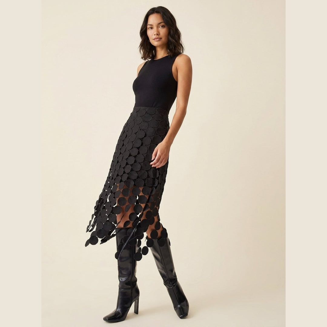 Luna black laser-cut disc midi skirt, three-quarter side view on model