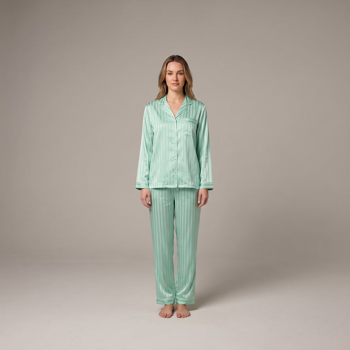 Luxe satin pyjama set in sage green, front view on model