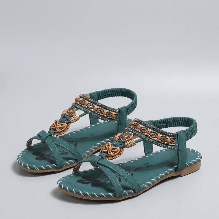 Green beaded flat sandal with elastic heel strap, front view