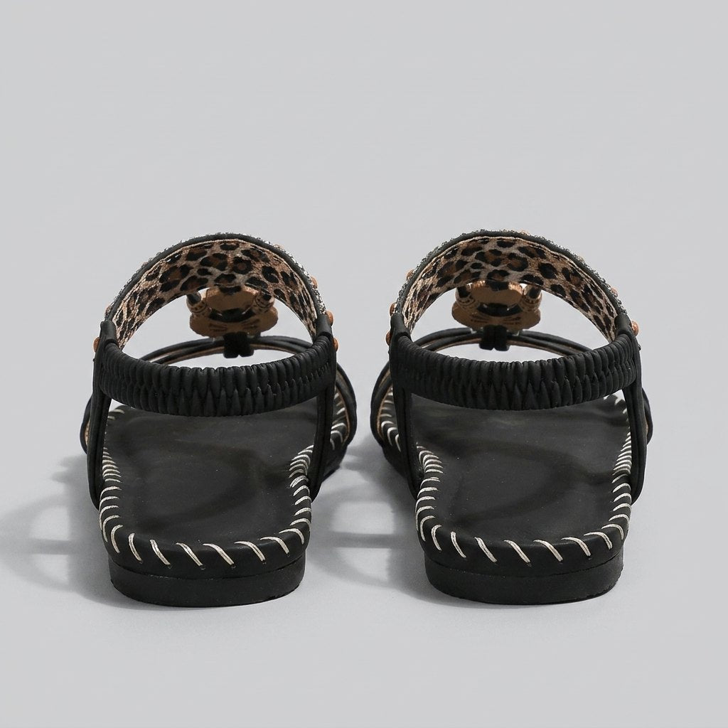 Beaded flat sandal seen from behind, showing the elastic heel strap