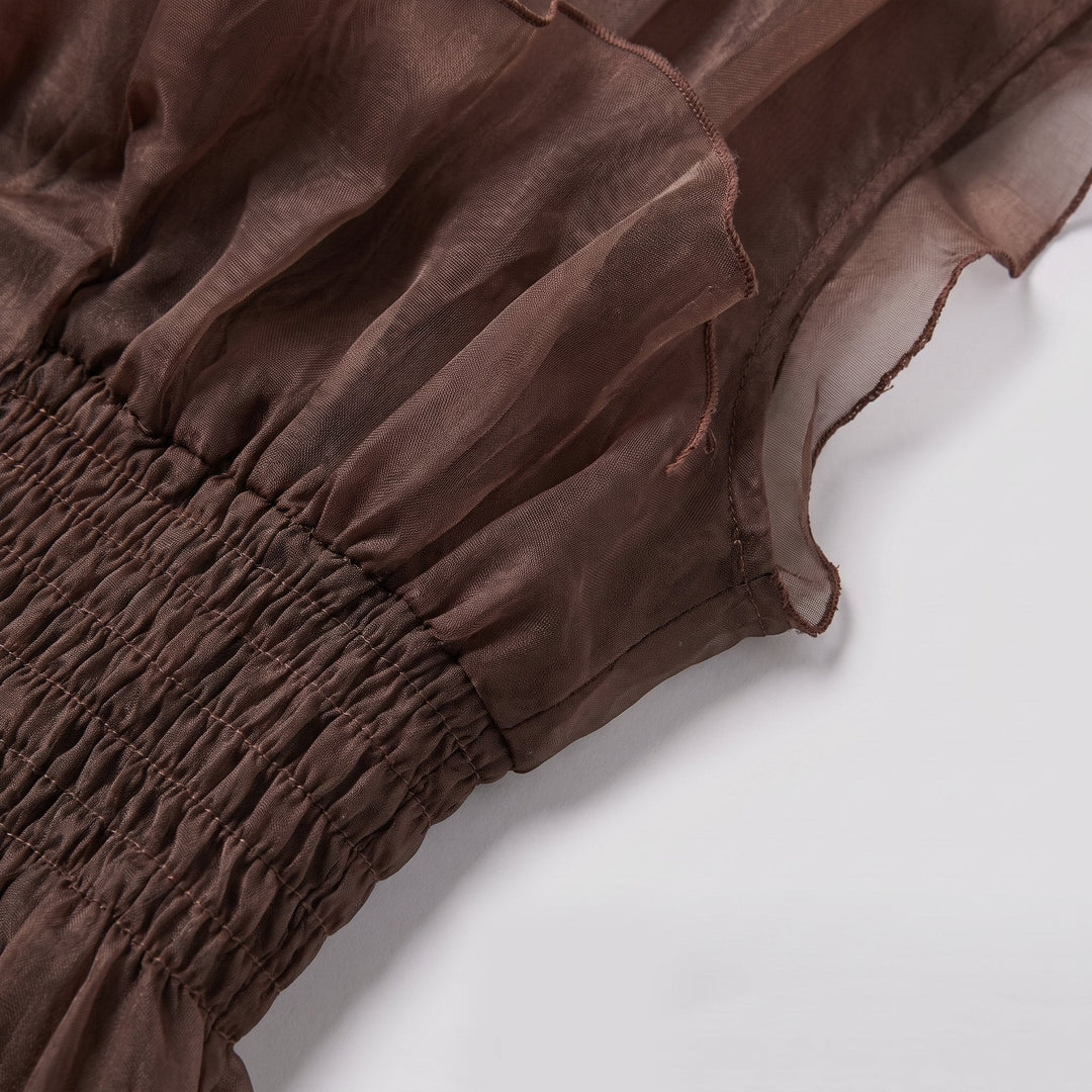 Close-up of the ruffled tier and sheer underlay in chocolate