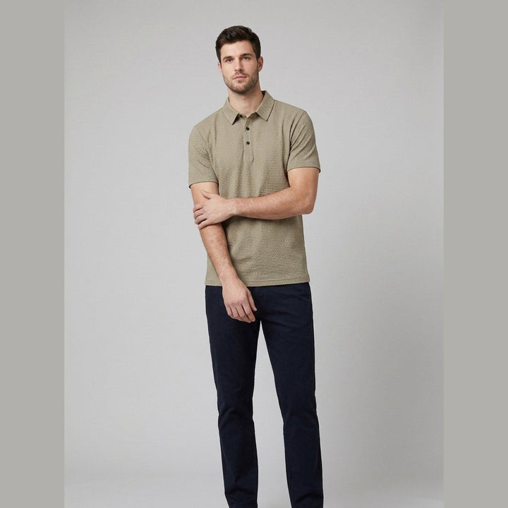 Beige short-sleeved golf polo shirt, front view on model