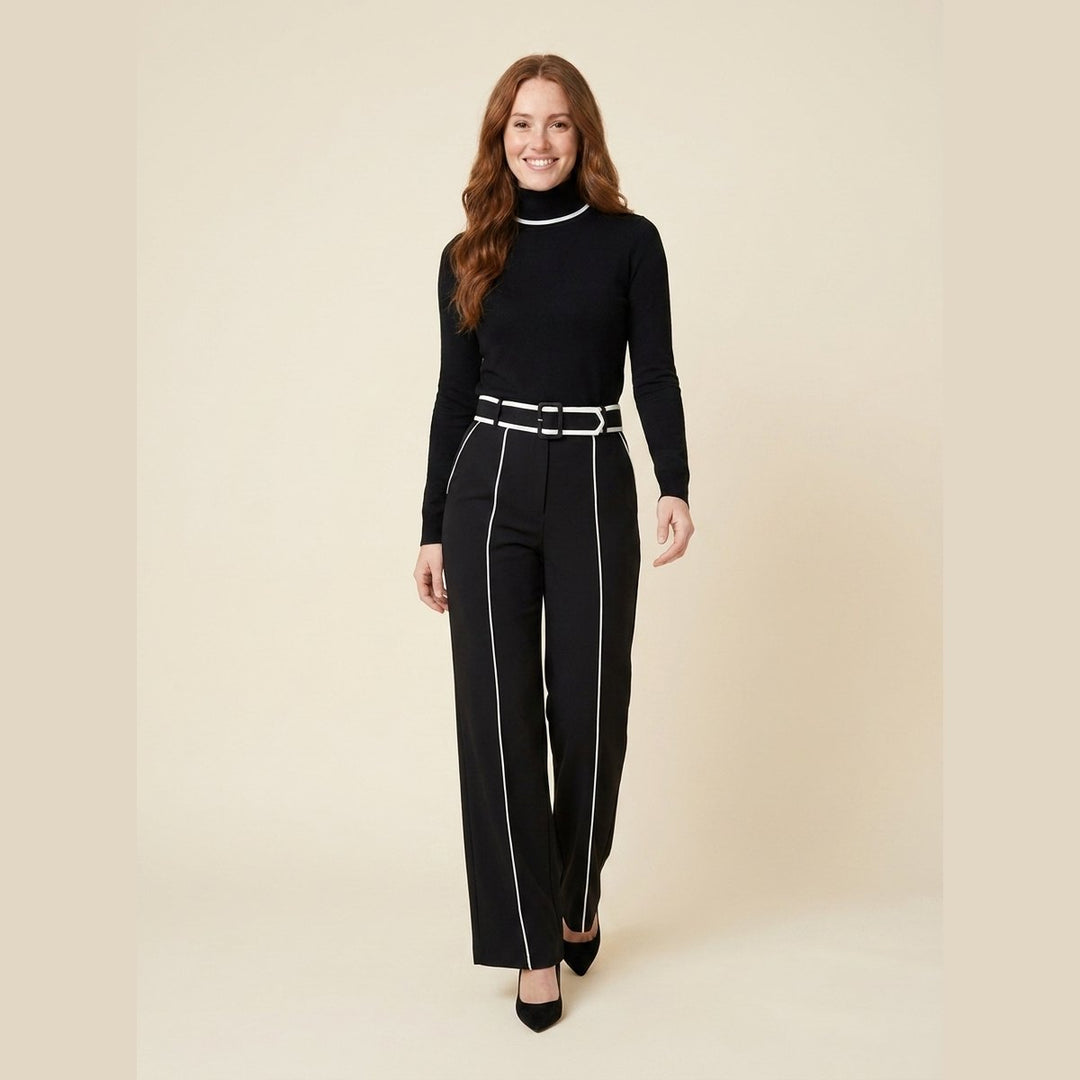 Mila black tailored knit jumpsuit with white piping and belt, on model walking