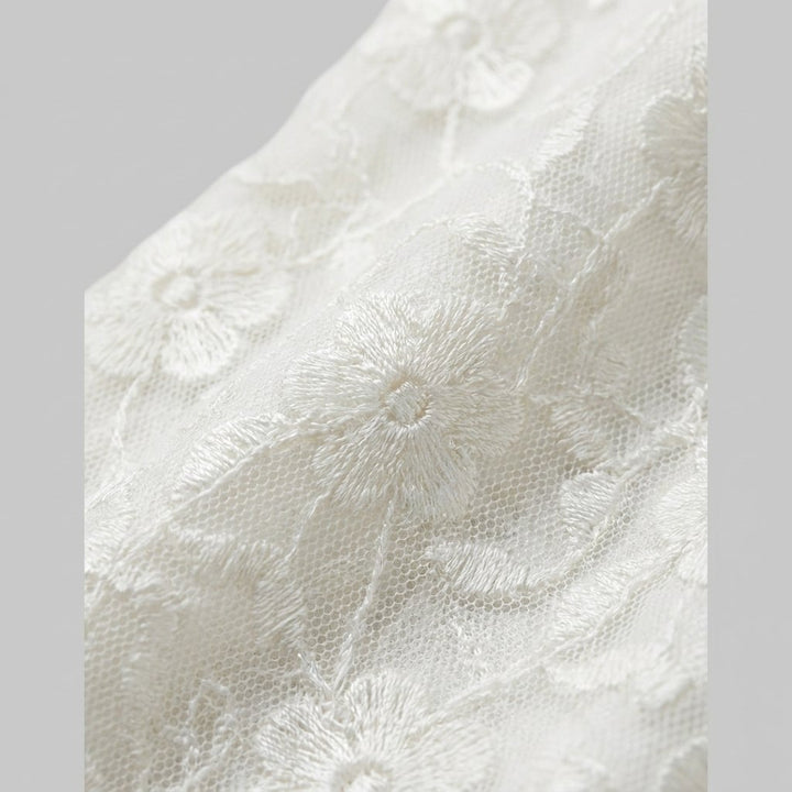 Misty white floral lace fabric close up