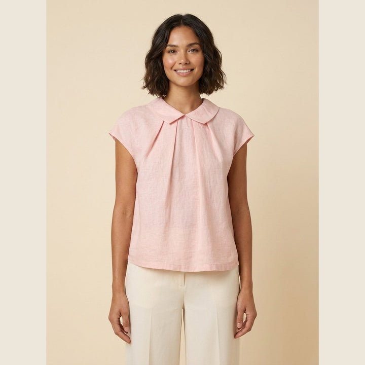 Pale blush linen pintuck top with A-line shape, front view on model