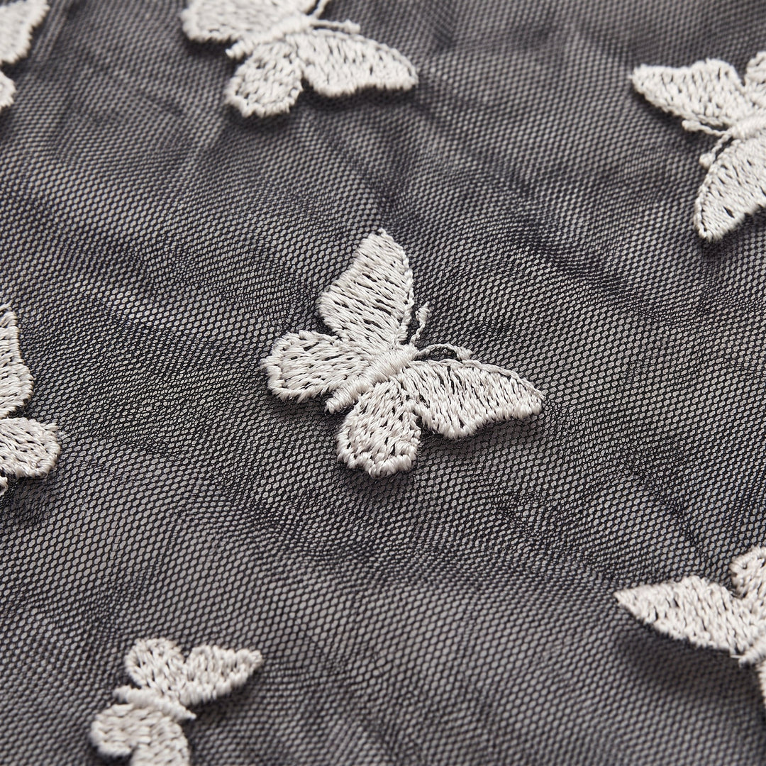 Sienna black mesh dress fabric close-up with butterfly embroidery