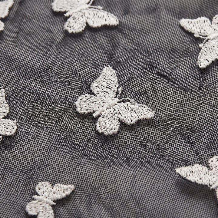 Sienna black mesh dress fabric close-up with butterfly embroidery