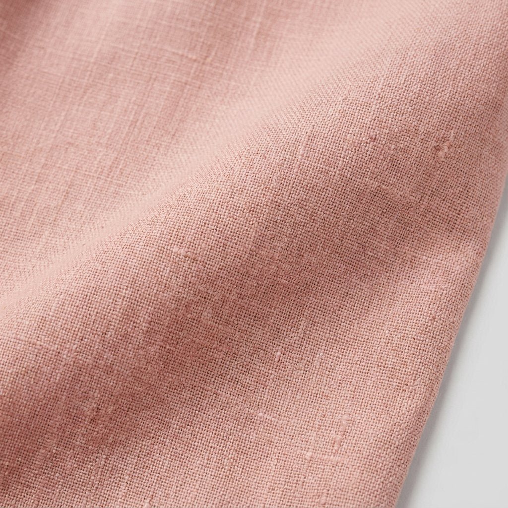 Cotton-linen fabric of the pink jumpsuit, close-up