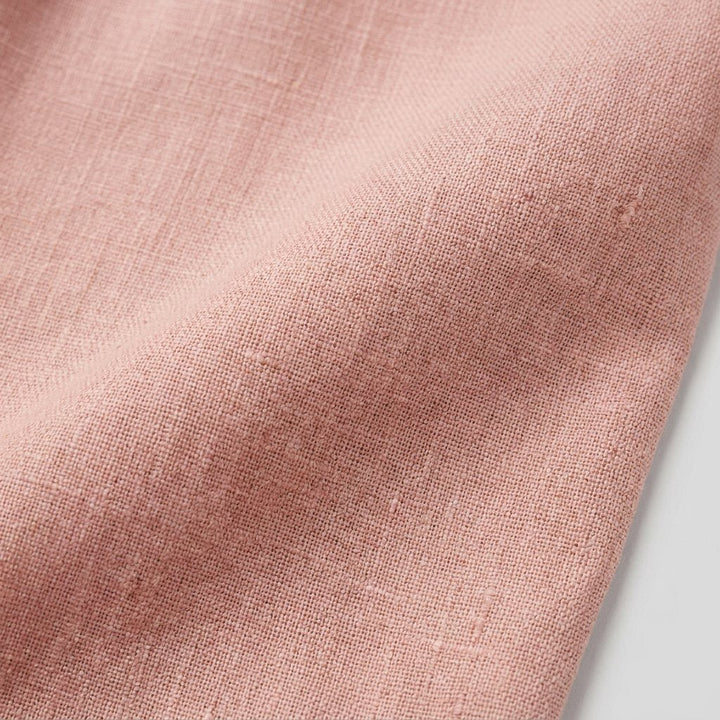 Cotton-linen fabric of the pink jumpsuit, close-up