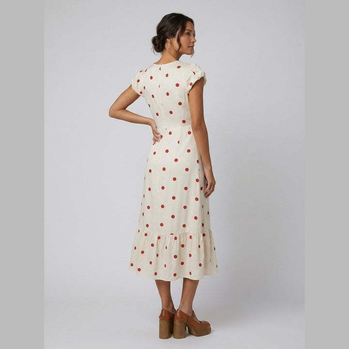 Sybille ivory and red polka dot midi dress side on model