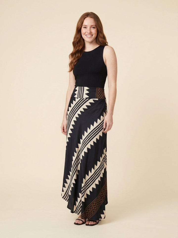 Black satin maxi skirt with geometric print, front view on model