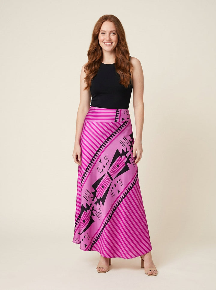 Pink satin maxi skirt with geometric print, front view on model